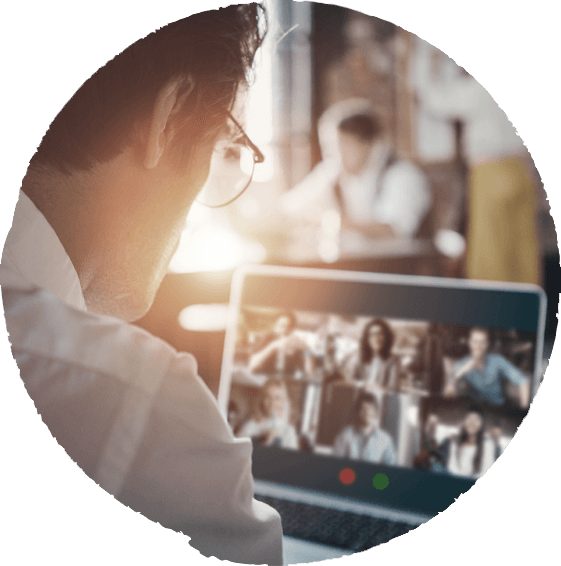 a man looks at a virtual workshop happening on the laptop in front of him