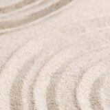 A picture of sand with lines in it like a zen garden