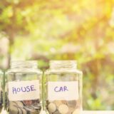 Three jars with change in them in an outdoor setting